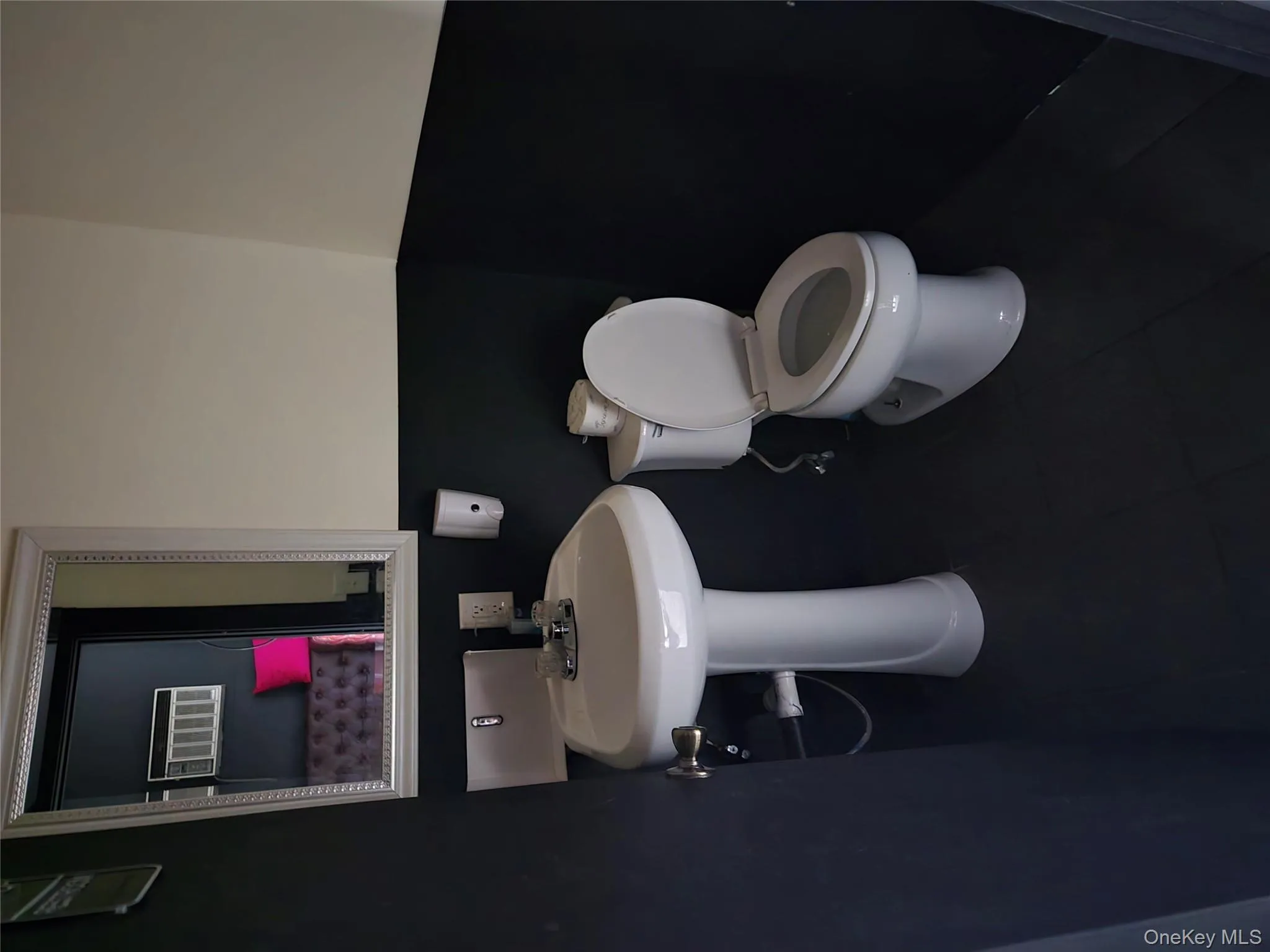 Half bathroom featuring toilet and tile patterned flooring Half bathroom featuring toilet and tile patterned flooring