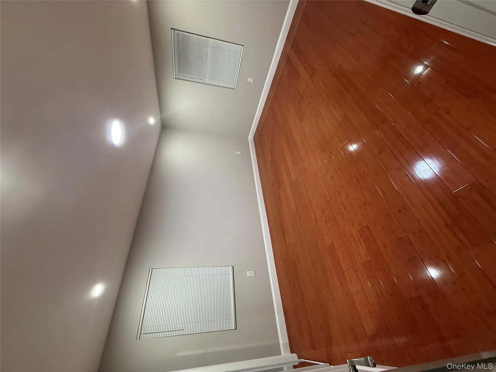 Spare room with hardwood / wood-style flooring and recessed lighting Spare room with hardwood / wood-style flooring and recessed lighting