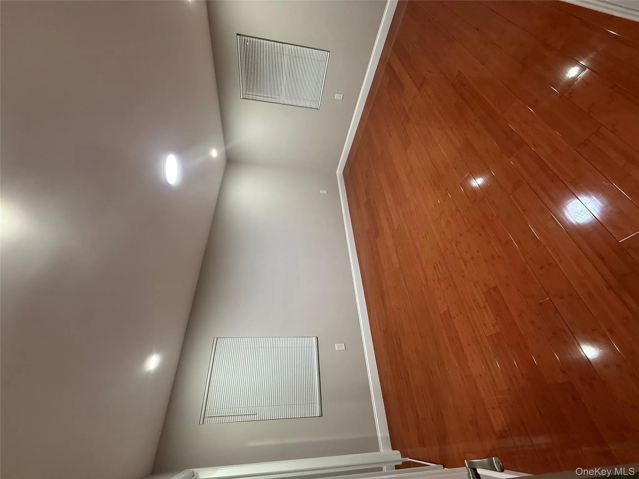 Spare room featuring dark wood-style flooring and recessed lighting Spare room featuring dark wood-style flooring and recessed lighting