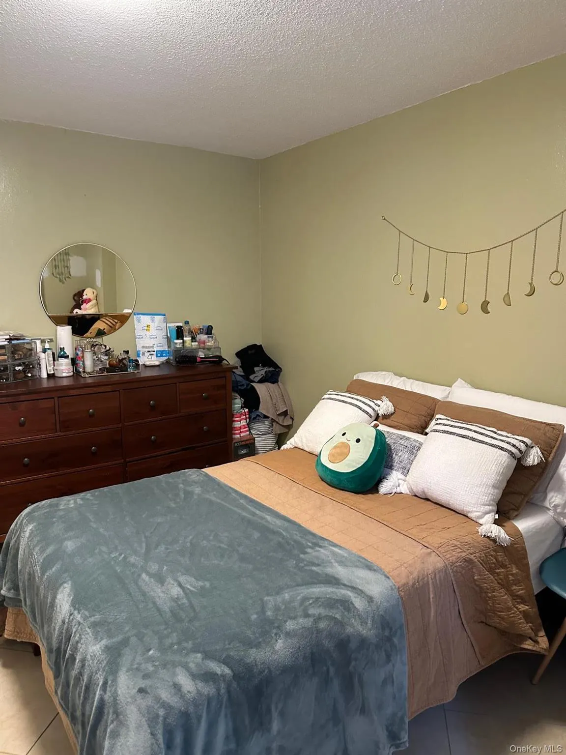 Tiled bedroom featuring a textured ceiling Tiled bedroom featuring a textured ceiling