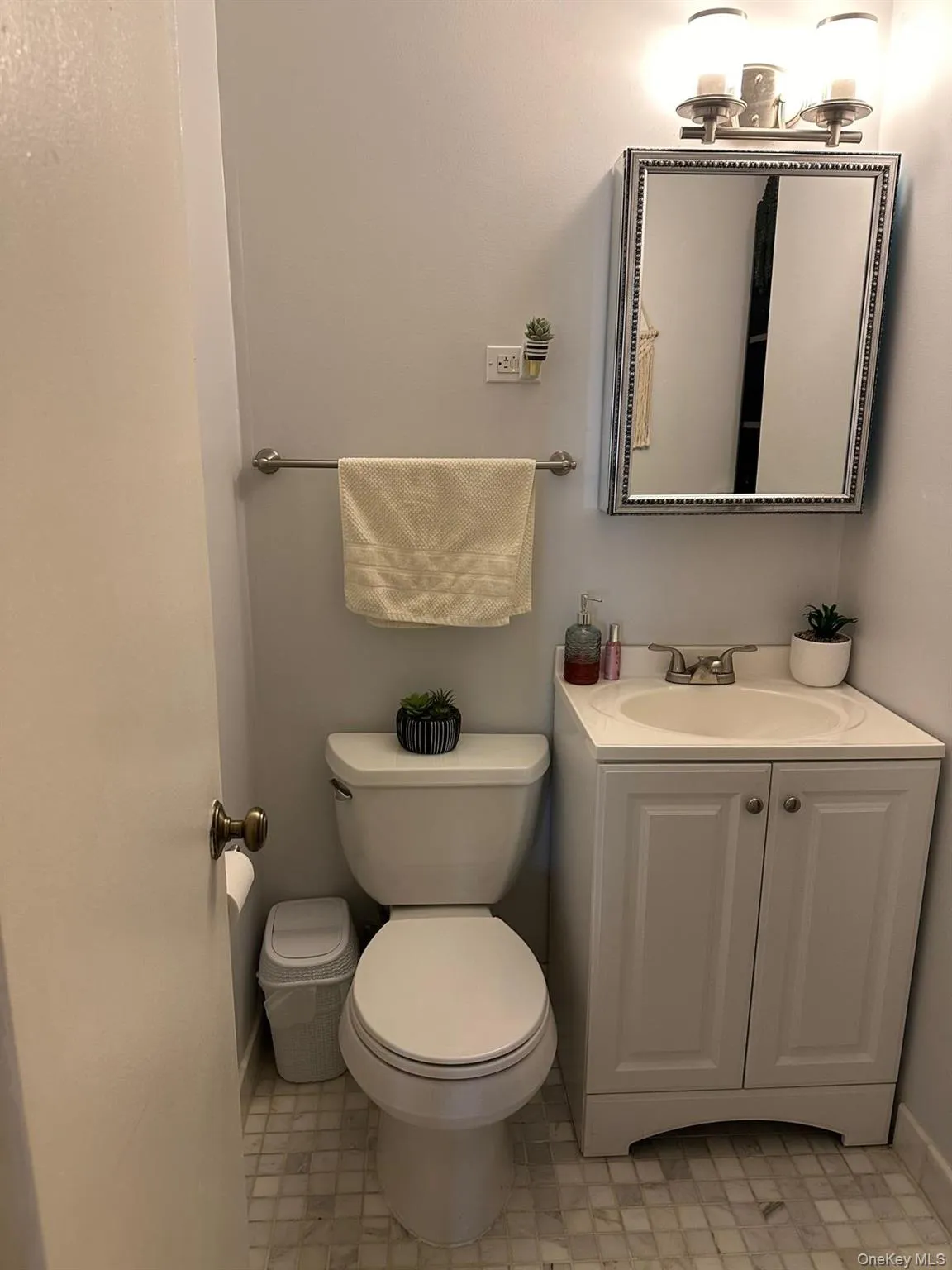 Half bathroom featuring vanity and toilet Half bathroom featuring vanity and toilet