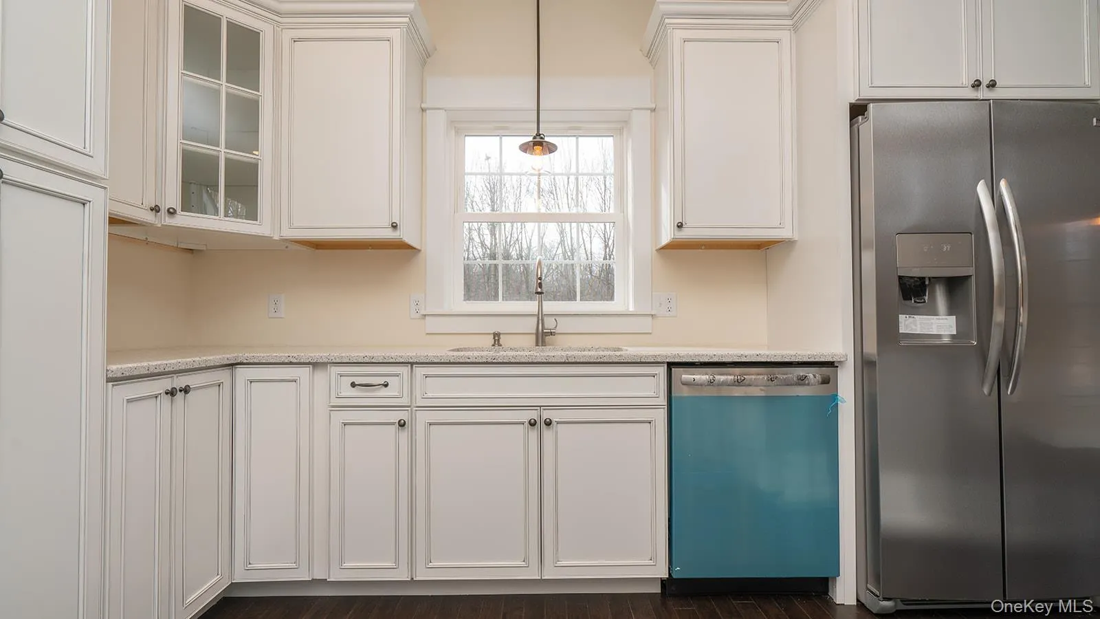 Kitchen featuring stainless steel refrigerator with ice dispenser, dishwasher, white cabinets, and pendant lighting Kitchen featuring stainless steel refrigerator with ice dispenser, dishwasher, white cabinets, and pendant lighting