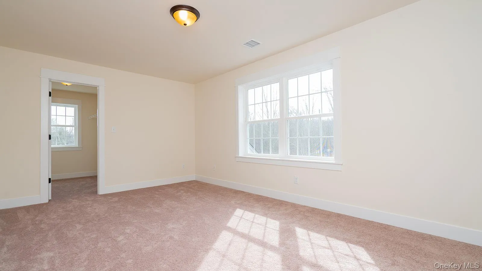 Unfurnished room with baseboards and light carpet Unfurnished room with baseboards and light carpet