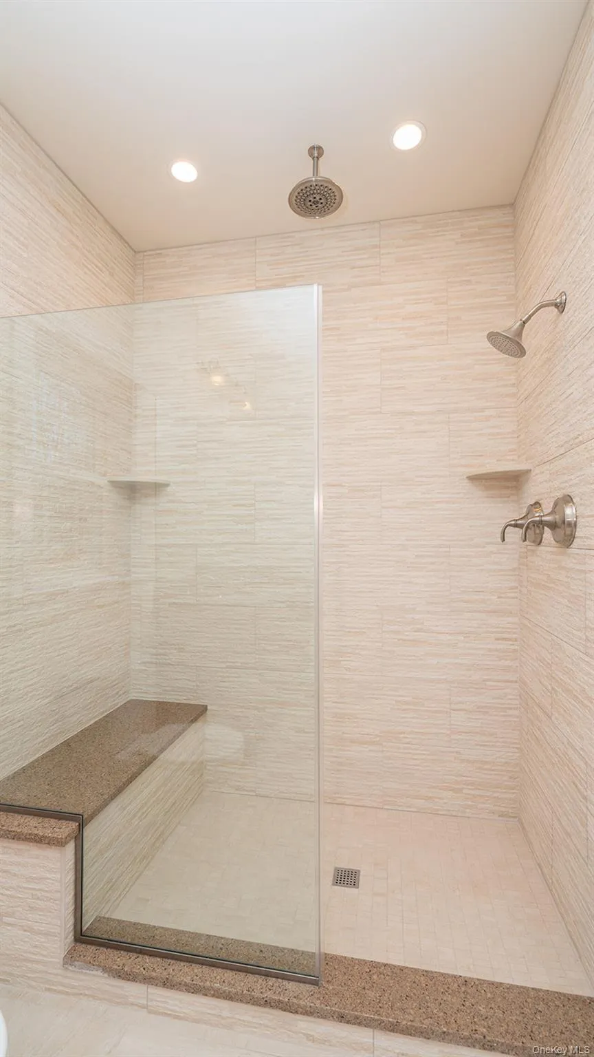 Bathroom featuring a tile shower and recessed lighting Bathroom featuring a tile shower and recessed lighting