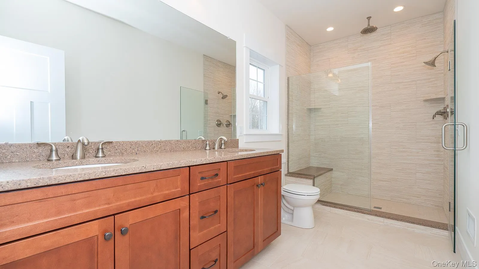 Full bathroom featuring double vanity, a shower stall, and recessed lighting Full bathroom featuring double vanity, a shower stall, and recessed lighting
