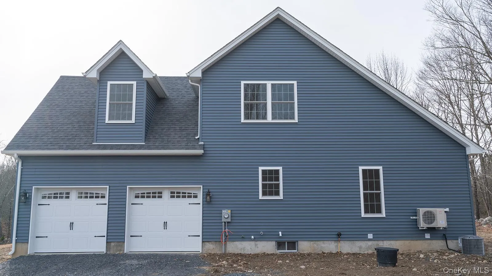 View of property exterior featuring a garage, roof with shingles, and driveway View of property exterior featuring a garage, roof with shingles, and driveway