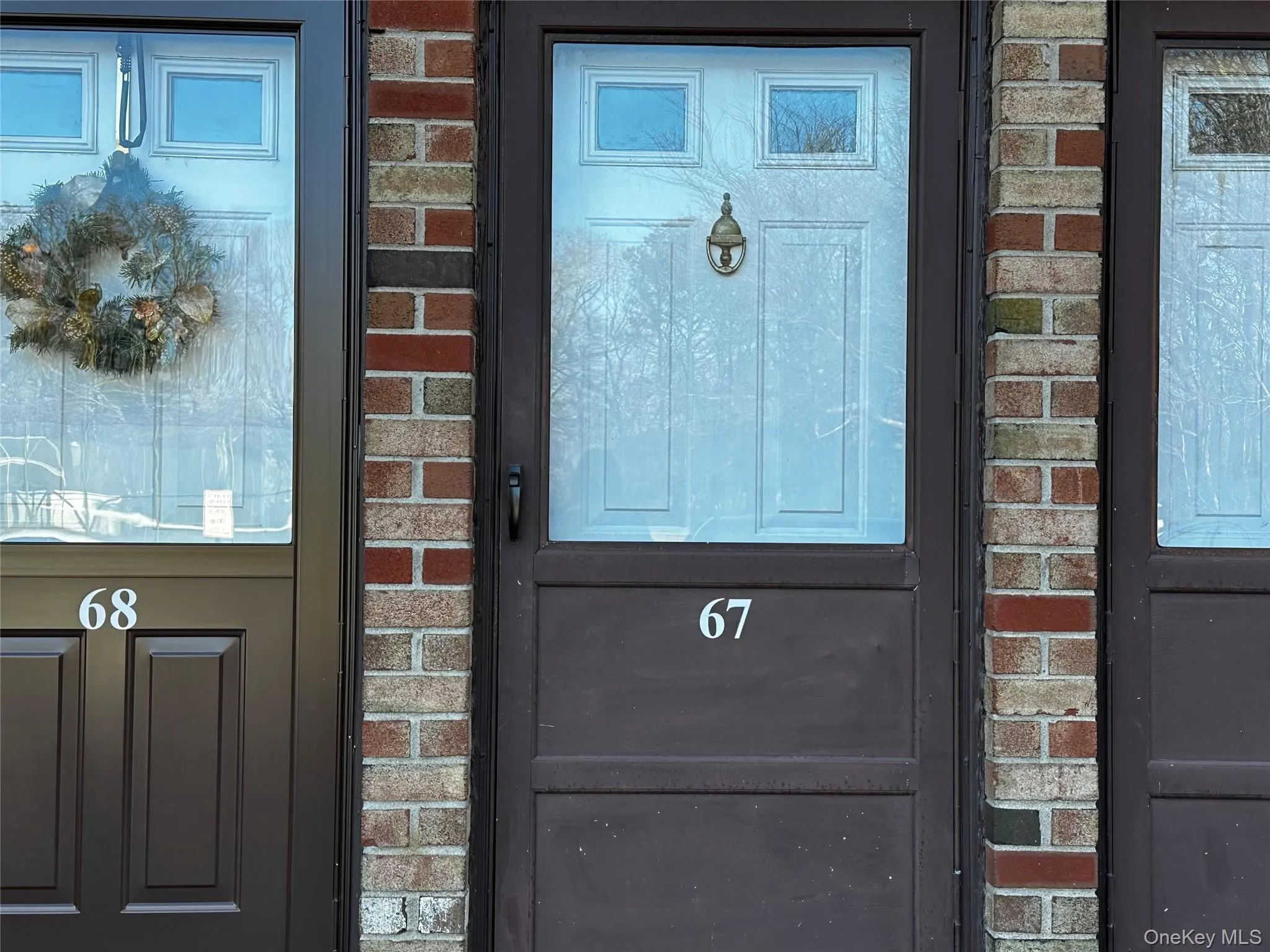 Property entrance featuring brick siding Property entrance featuring brick siding