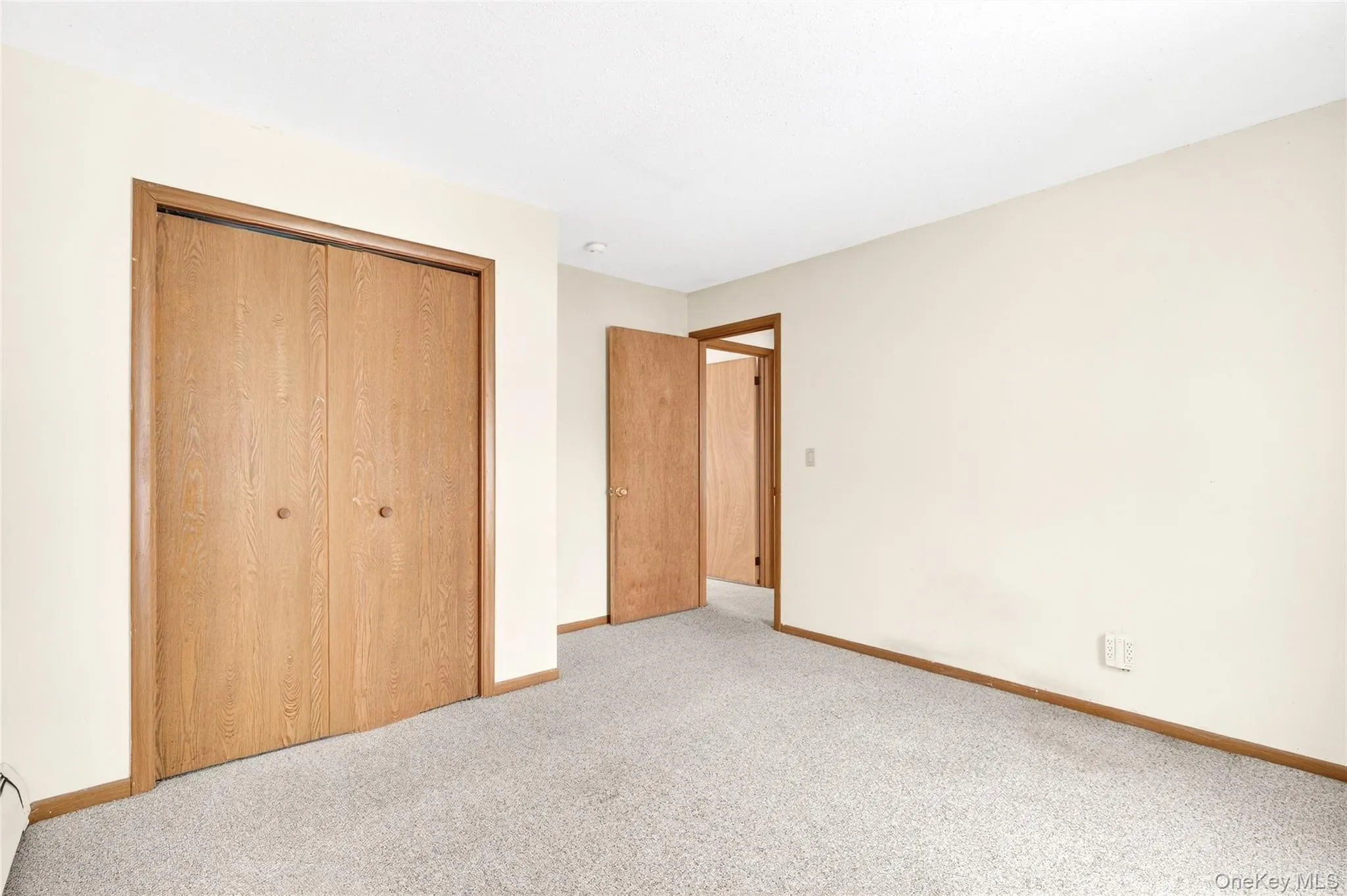 bedroom featuring a closet and carpet floors bedroom featuring a closet and carpet floors