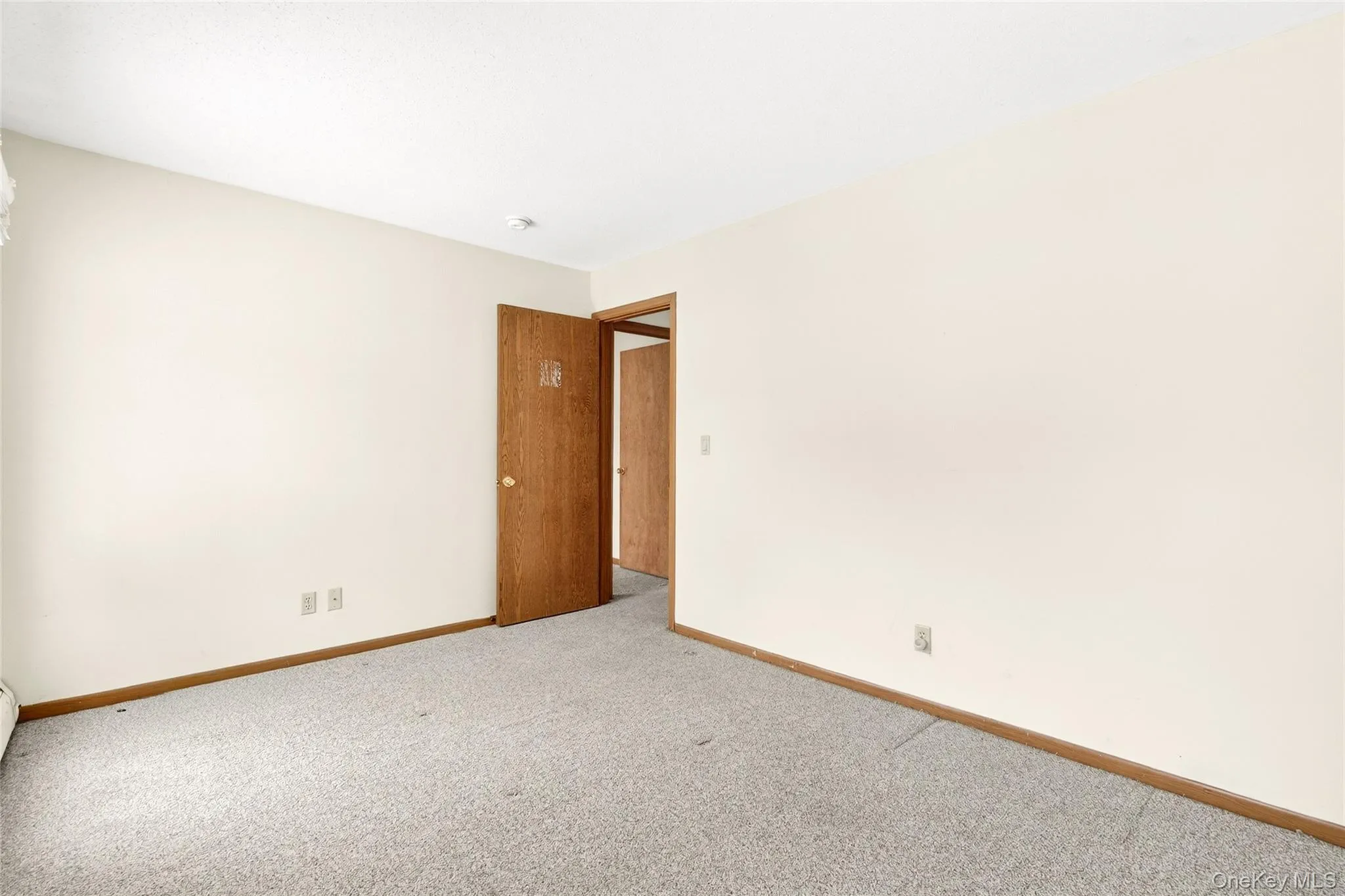 Spare room featuring carpet floors and baseboards Spare room featuring carpet floors and baseboards