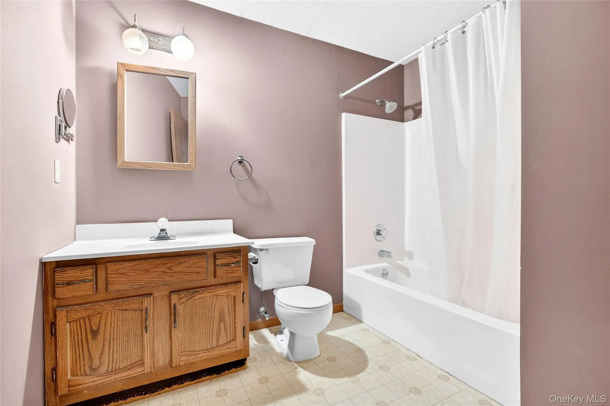 Full bath featuring shower / bath combo with shower curtain, vanity, and light floors Full bath featuring shower / bath combo with shower curtain, vanity, and light floors