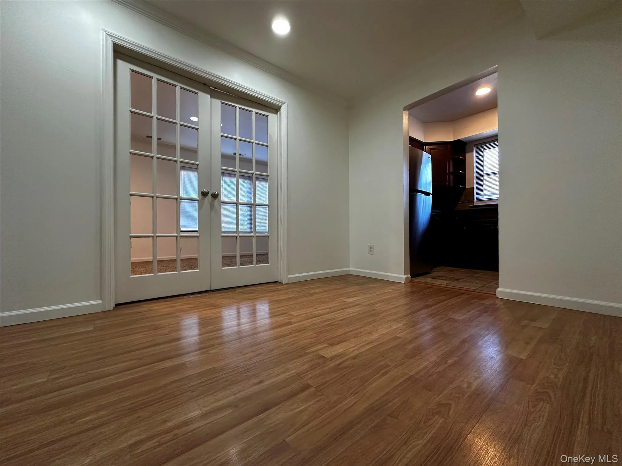 Dining room featuring laminate floors, recessed lighting, french doors, and ornamental molding Dining room featuring laminate floors, recessed lighting, french doors, and ornamental molding