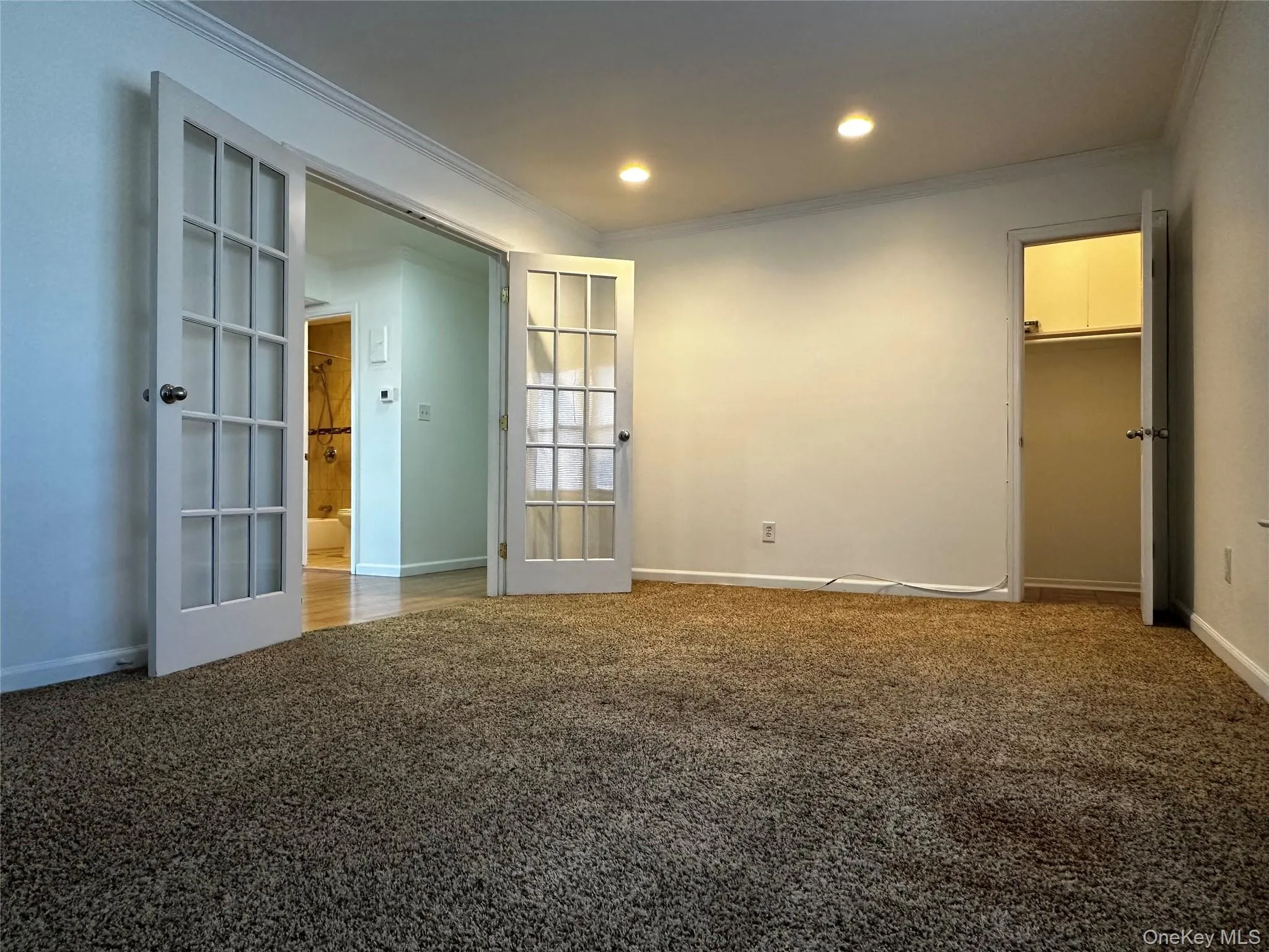 Living room with carpet flooring, crown molding, and recessed lighting Living room with carpet flooring, crown molding, and recessed lighting