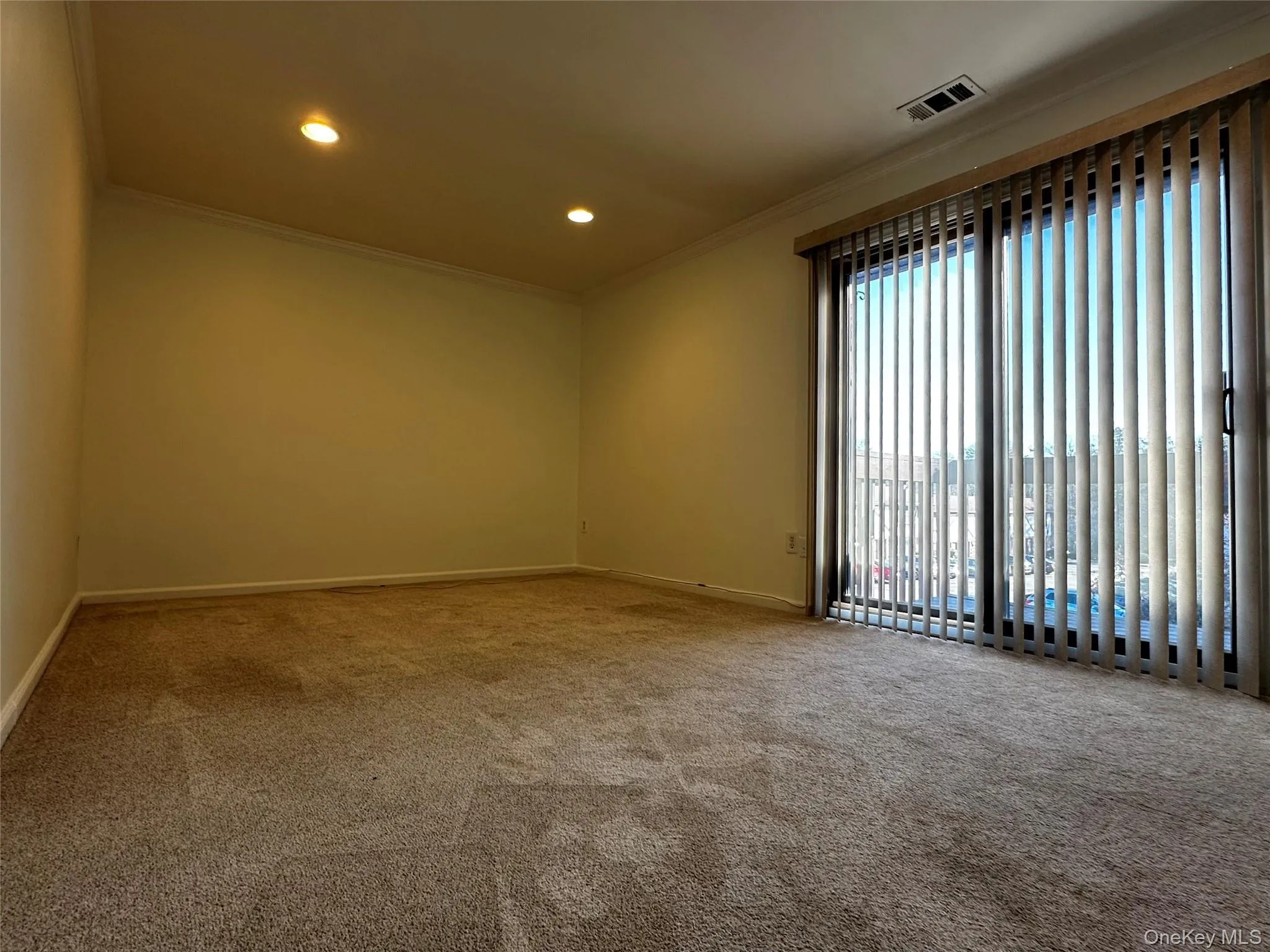 Carpeted bedroom with crown molding and recessed lighting Carpeted bedroom with crown molding and recessed lighting