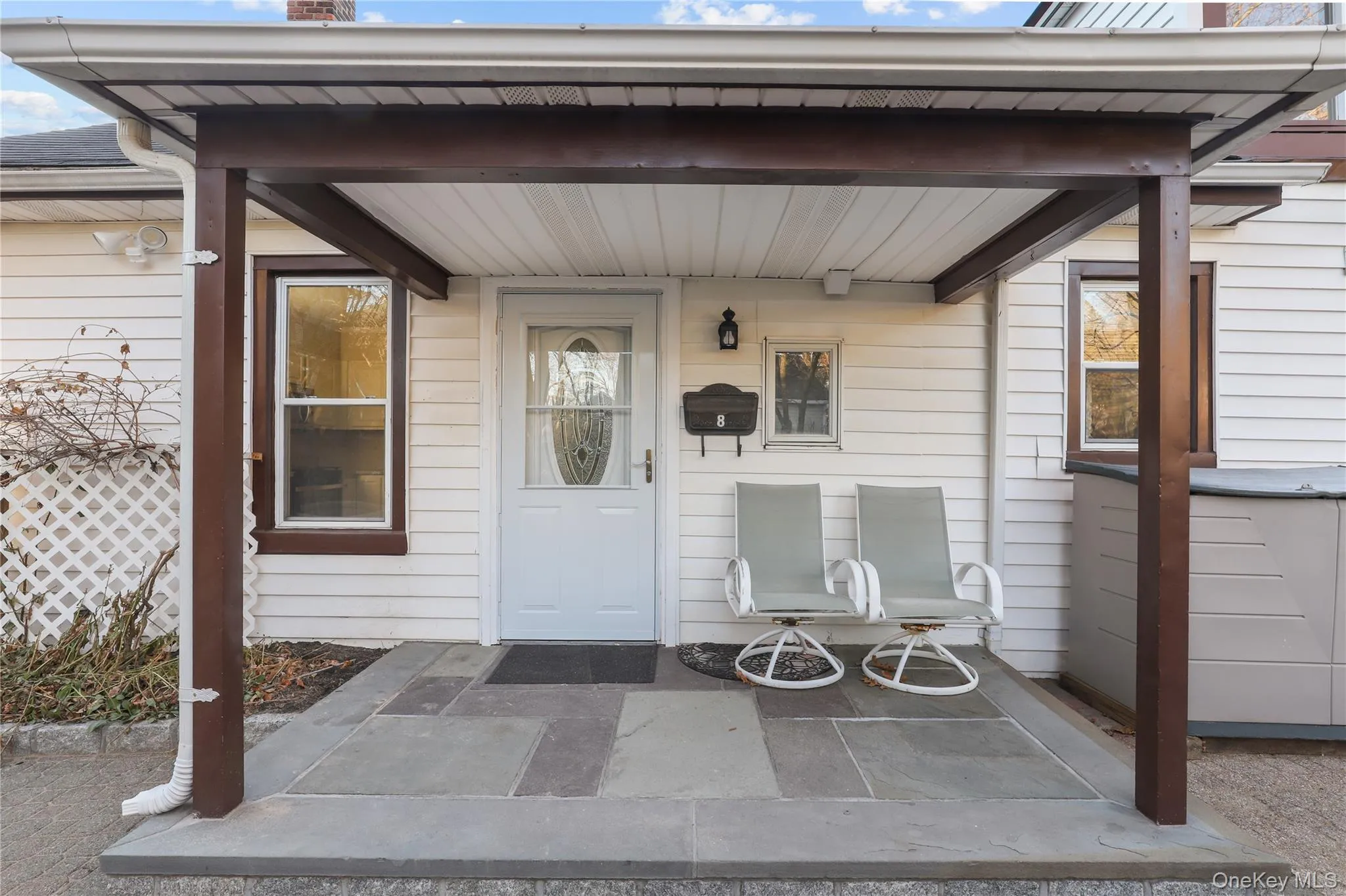 View of exterior entry with covered porch and a chimney View of exterior entry with covered porch and a chimney