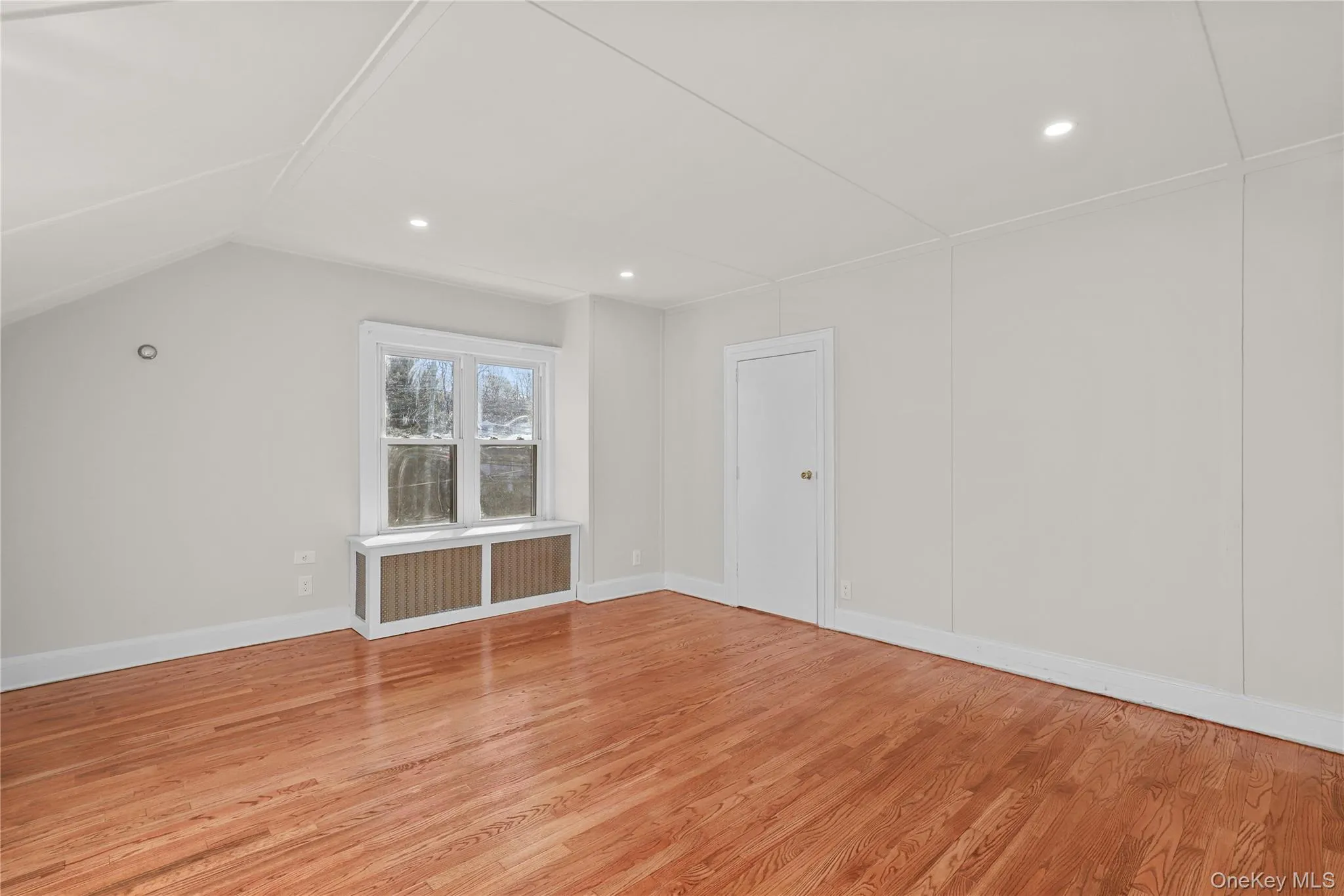 Bonus room featuring radiator, light wood-style floors, and recessed lighting Bonus room featuring radiator, light wood-style floors, and recessed lighting