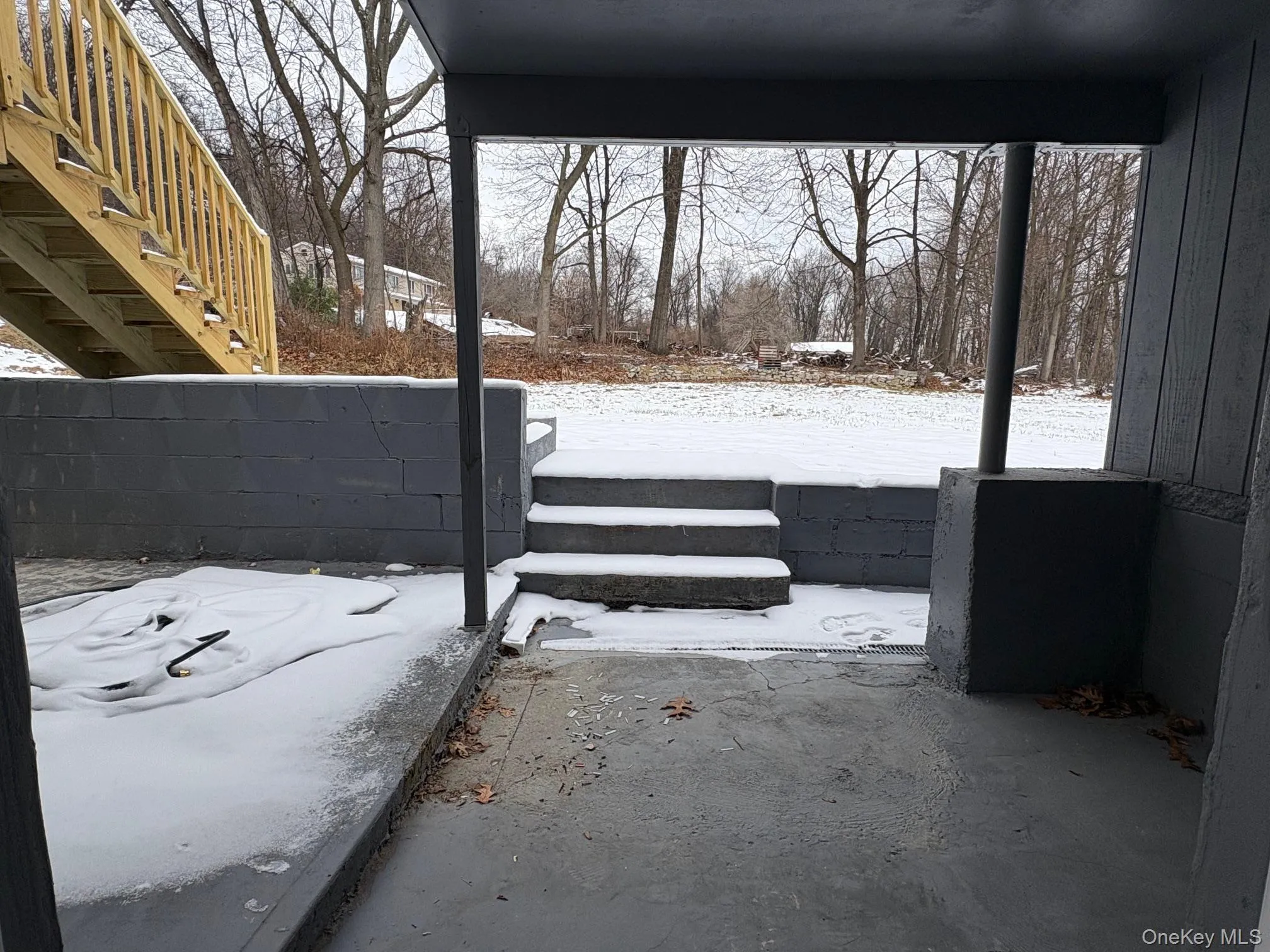 Yard layered in snow featuring stairs Yard layered in snow featuring stairs