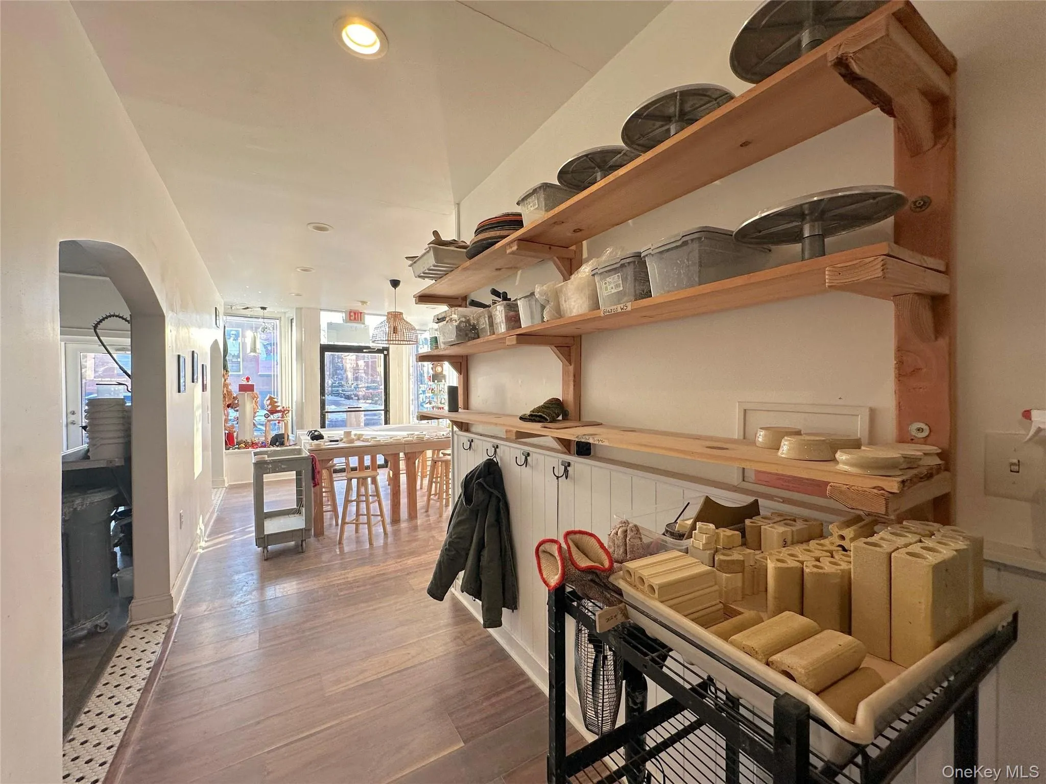Dining room with wood finished floors, recessed lighting, and arched walkways Dining room with wood finished floors, recessed lighting, and arched walkways