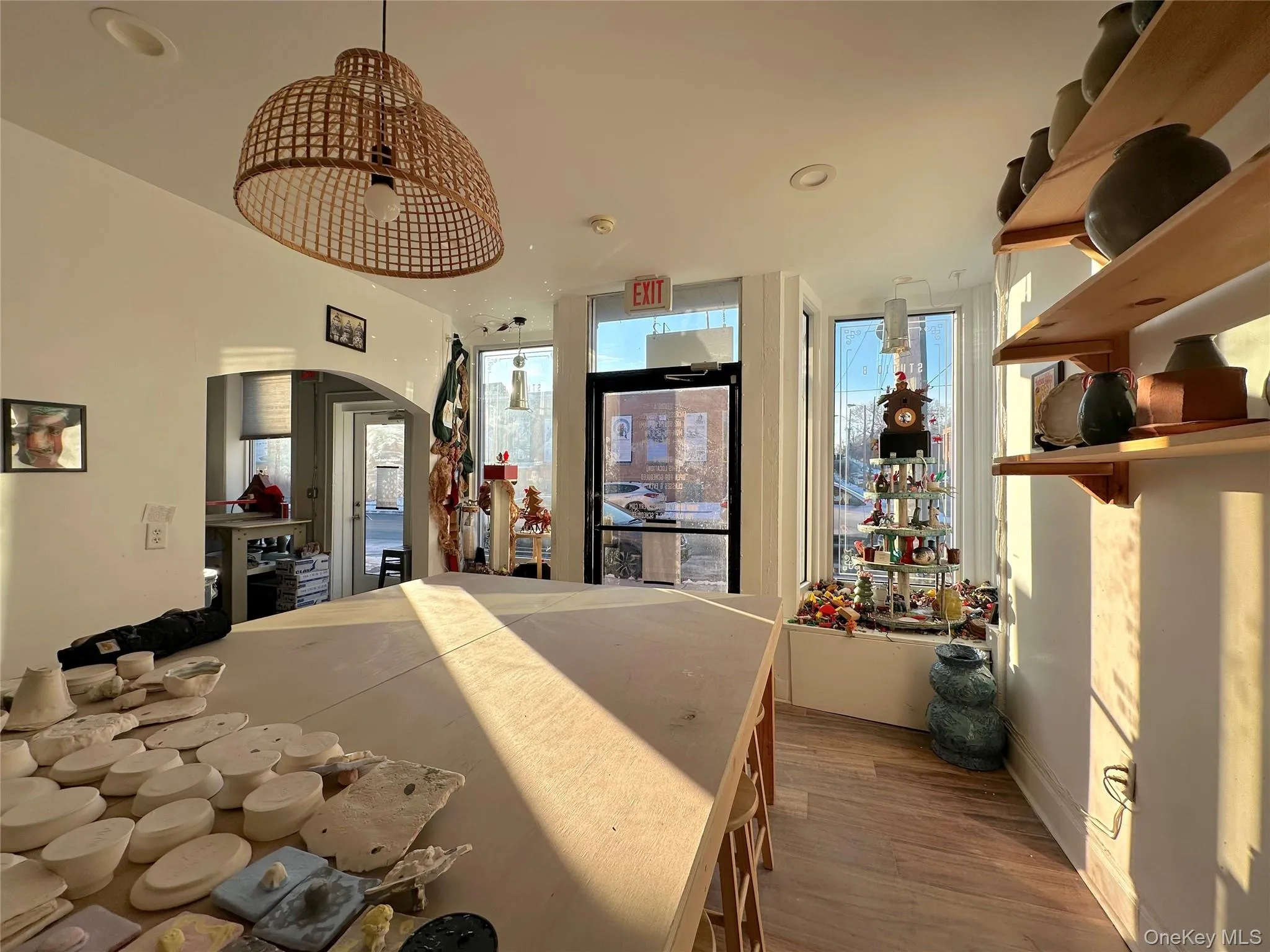 Bedroom with dark wood-type flooring and arched walkways Bedroom with dark wood-type flooring and arched walkways