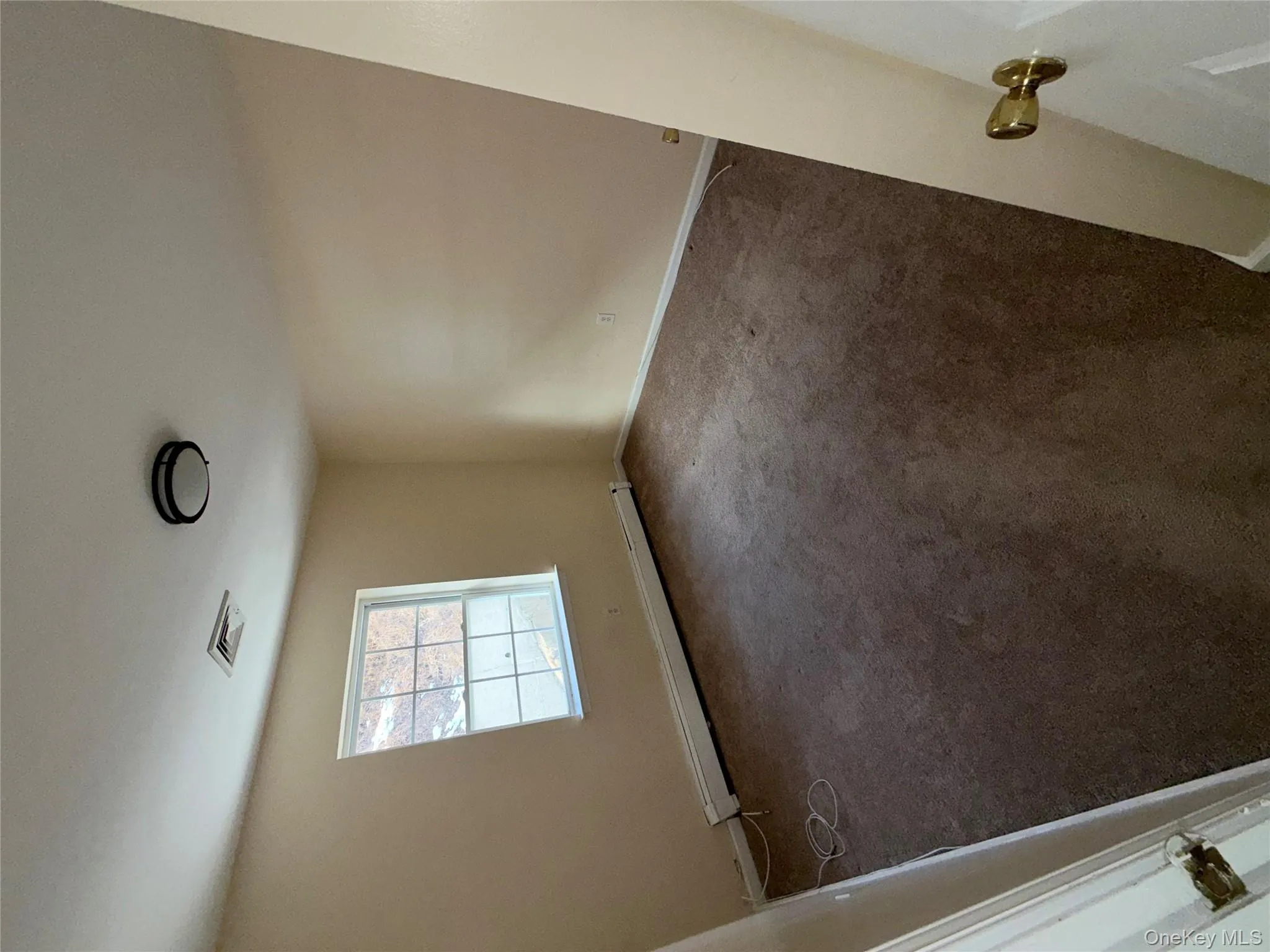 Spare room with a baseboard radiator and carpet Spare room with a baseboard radiator and carpet