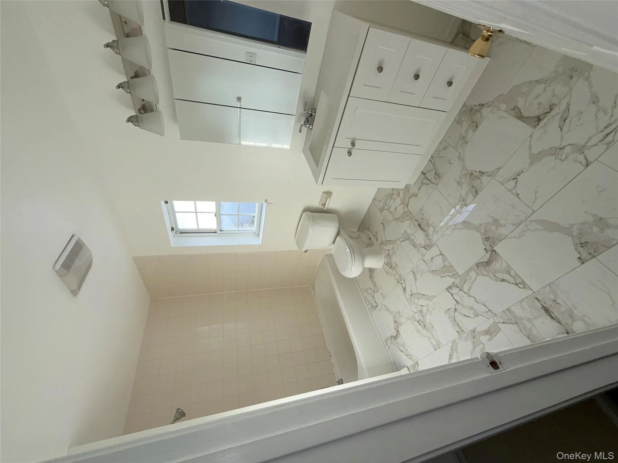 Bathroom featuring vanity, light marble finish flooring, and tub / shower combination Bathroom featuring vanity, light marble finish flooring, and tub / shower combination