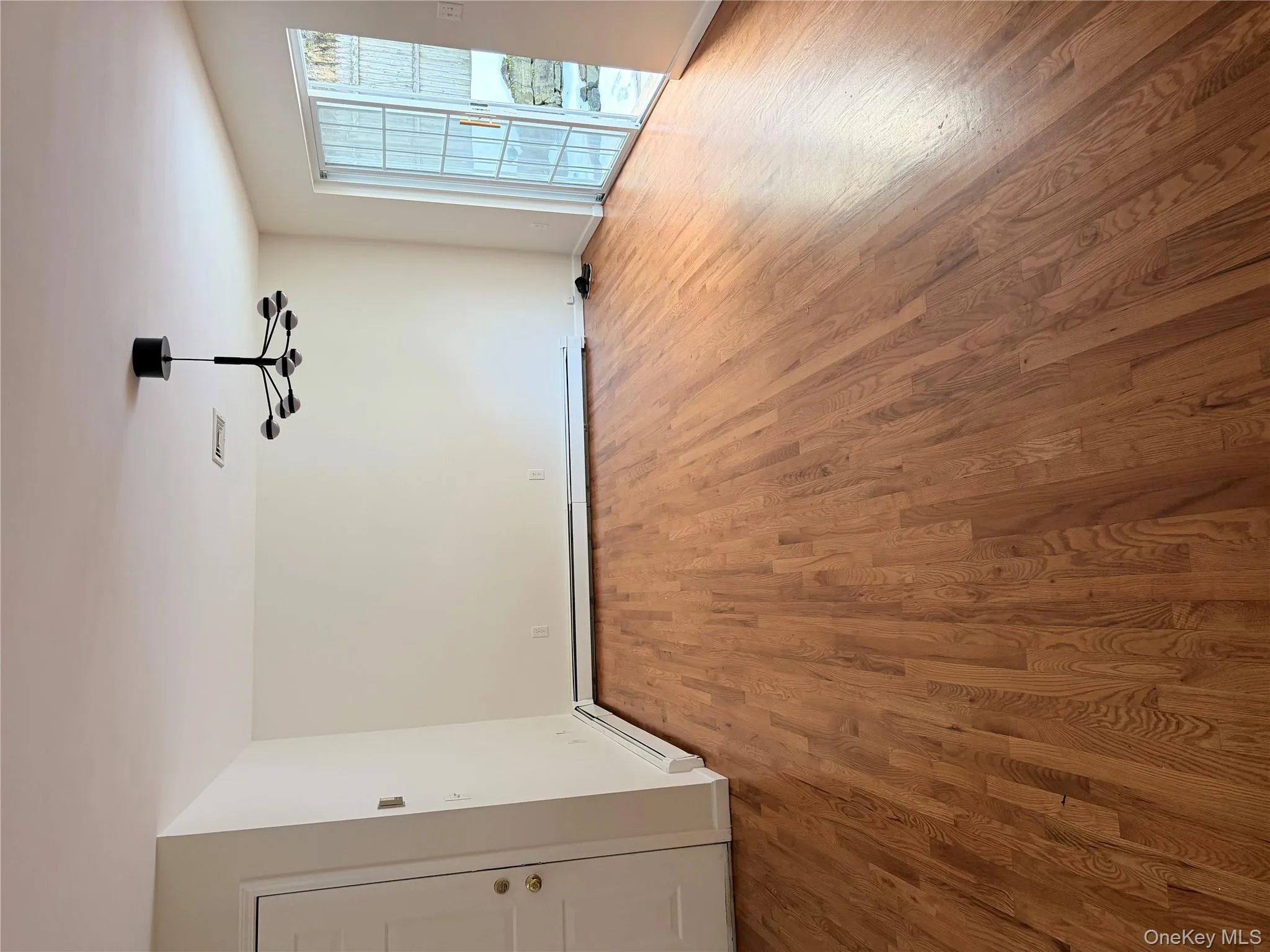 Unfurnished dining area with light wood-style floors, a chandelier, and a baseboard heating unit Unfurnished dining area with light wood-style floors, a chandelier, and a baseboard heating unit