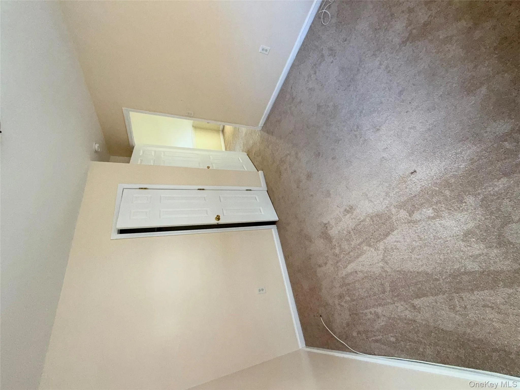 Carpeted empty room featuring baseboards Carpeted empty room featuring baseboards