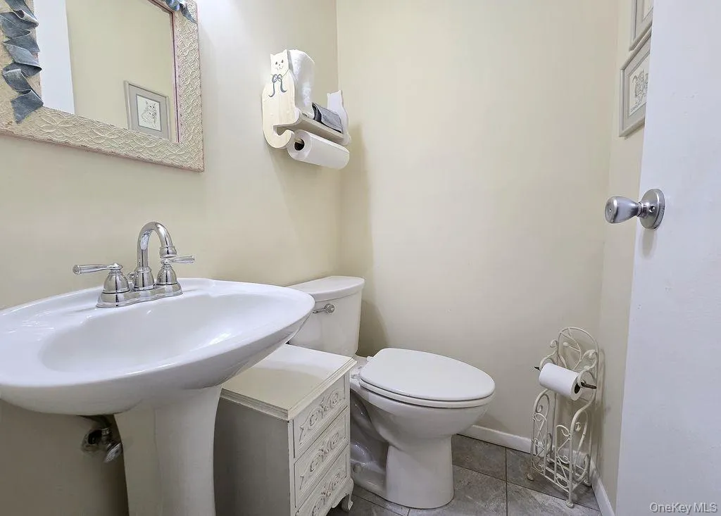 Bathroom with tile patterned flooring and toilet Bathroom with tile patterned flooring and toilet