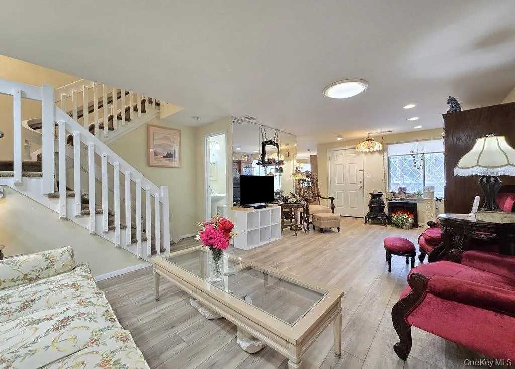 Living room with stairway and light wood-style flooring Living room with stairway and light wood-style flooring