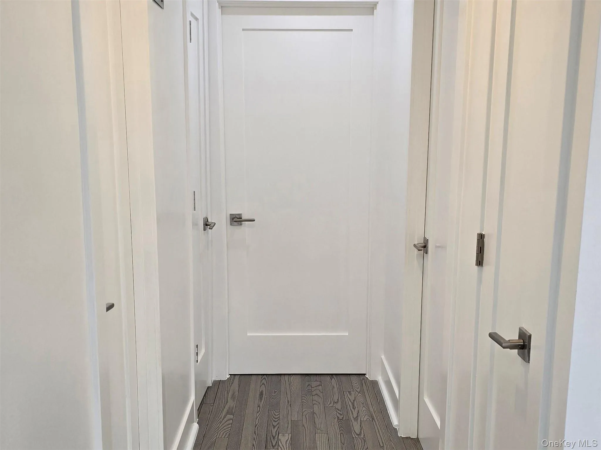 Hall featuring dark wood-type flooring Hall featuring dark wood-type flooring