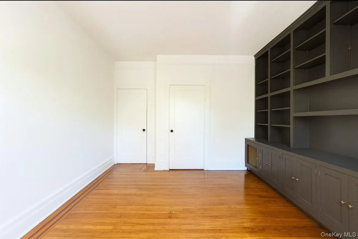 Unfurnished bedroom featuring light wood-style flooring and baseboards Unfurnished bedroom featuring light wood-style flooring and baseboards
