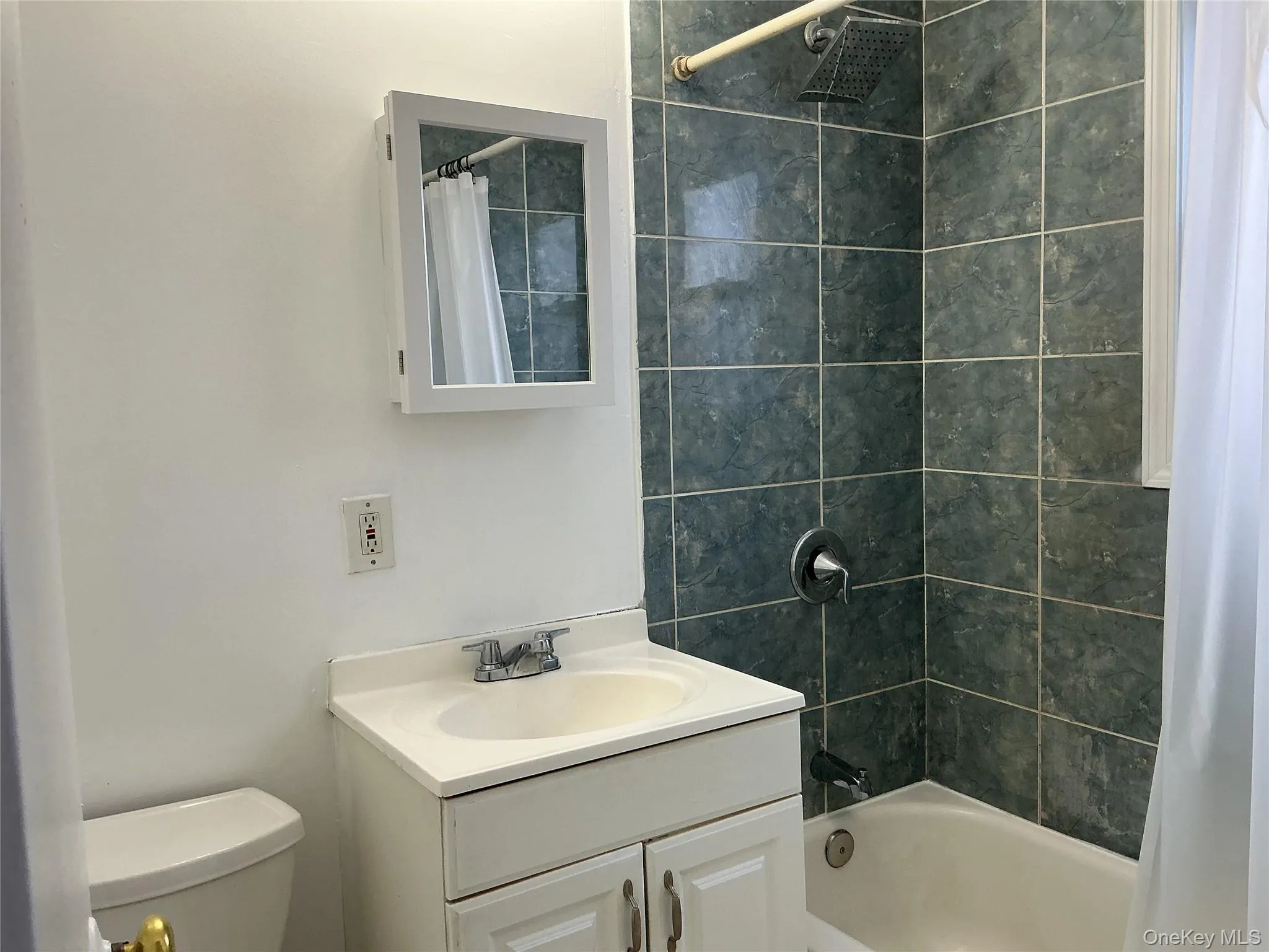 Full bath featuring vanity and shower / bath combination with curtain Full bath featuring vanity and shower / bath combination with curtain