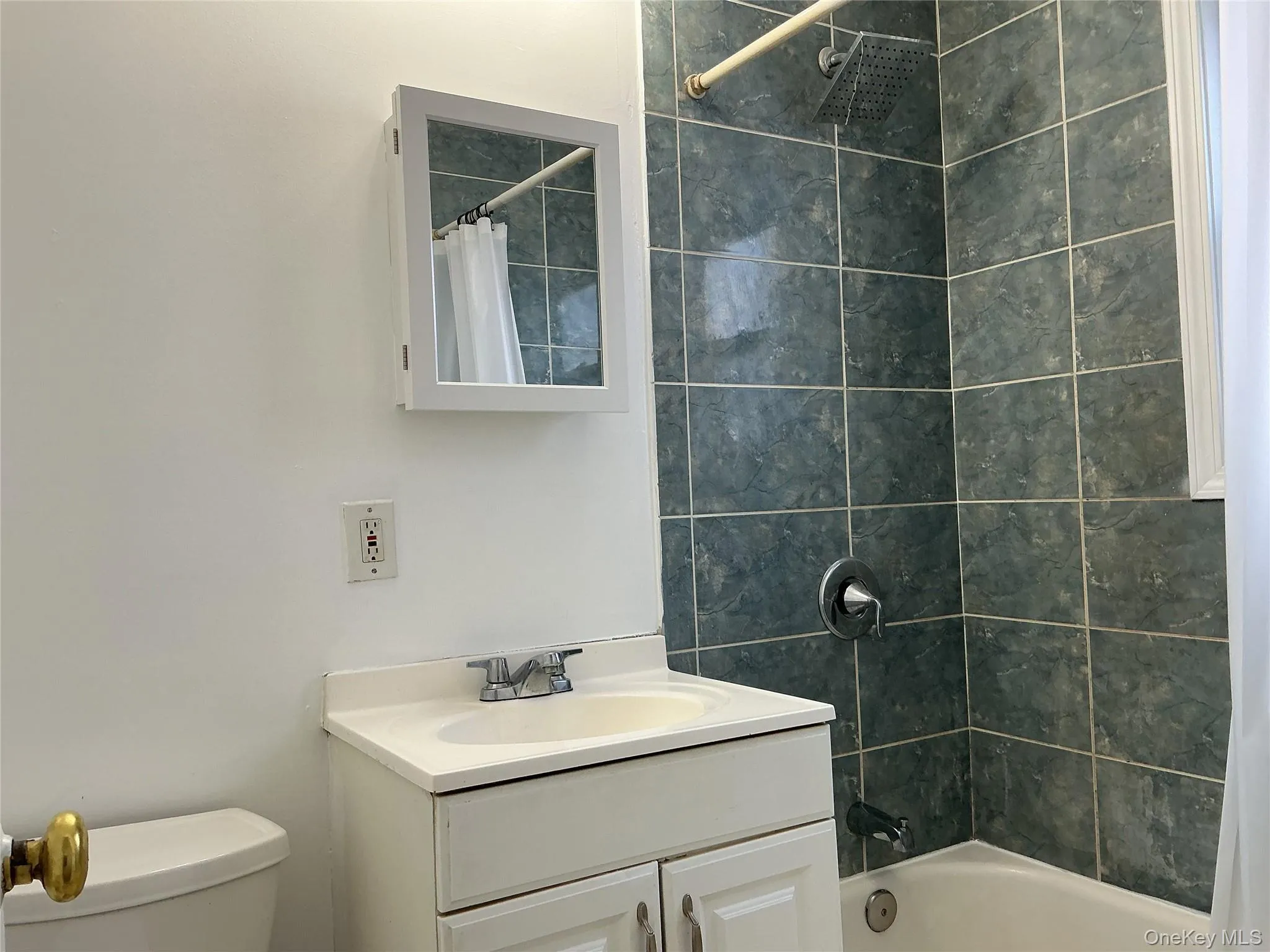 Bathroom featuring vanity and shower / bath combination with curtain Bathroom featuring vanity and shower / bath combination with curtain