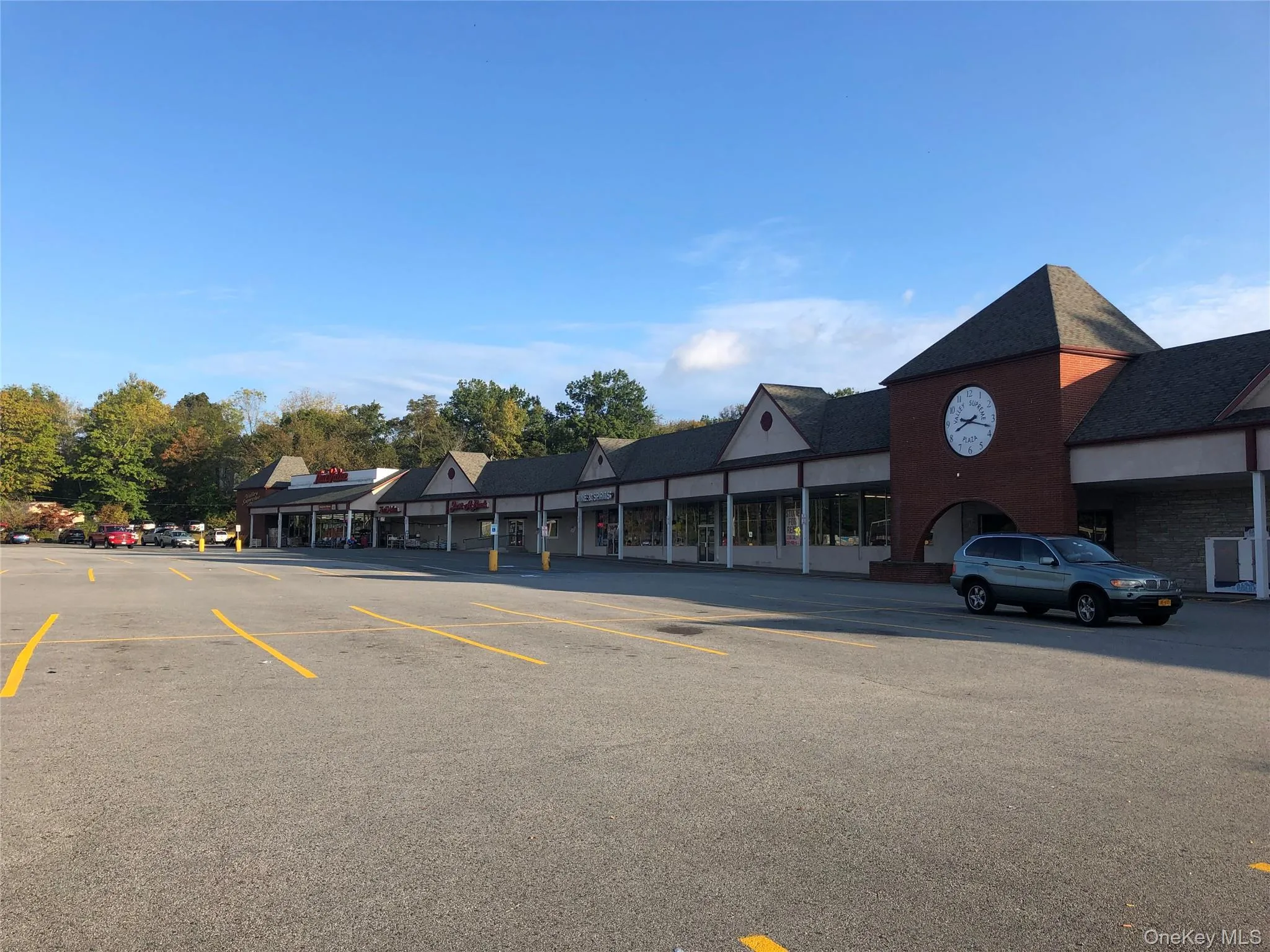 View of commercial property with uncovered parking View of commercial property with uncovered parking