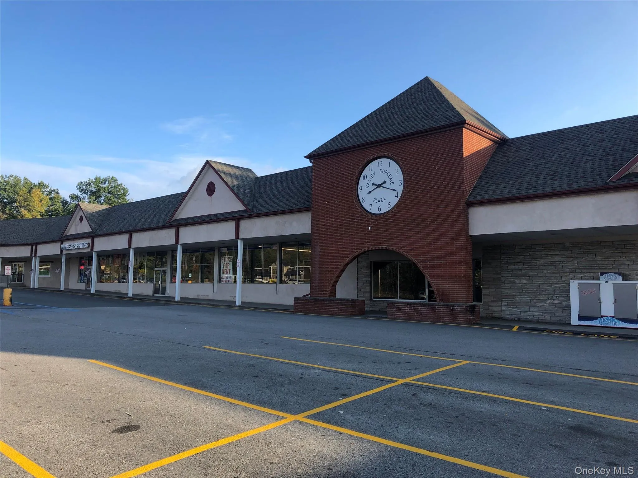 View of commercial property with uncovered parking View of commercial property with uncovered parking