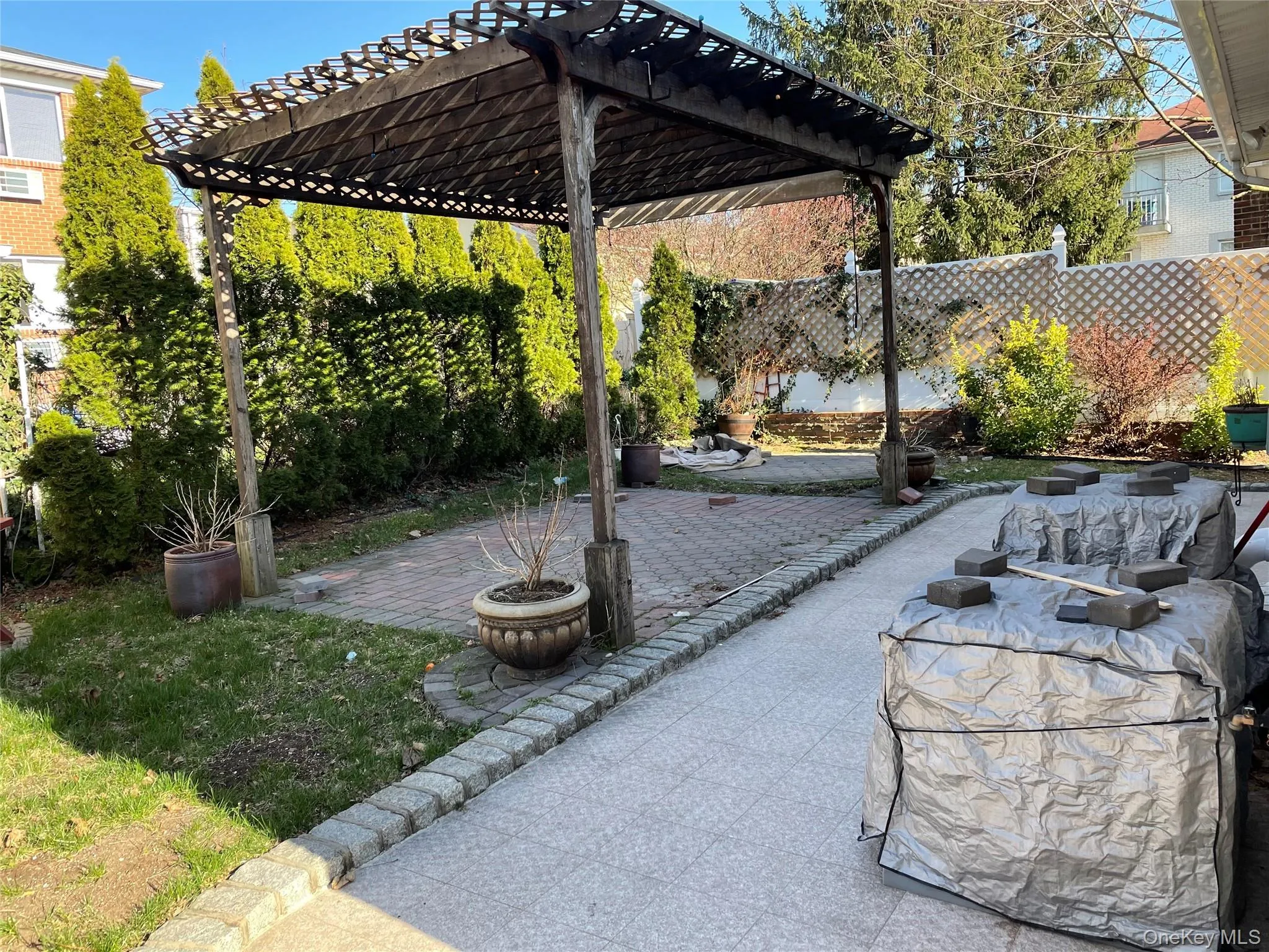 Fenced backyard featuring a patio area and a pergola Fenced backyard featuring a patio area and a pergola