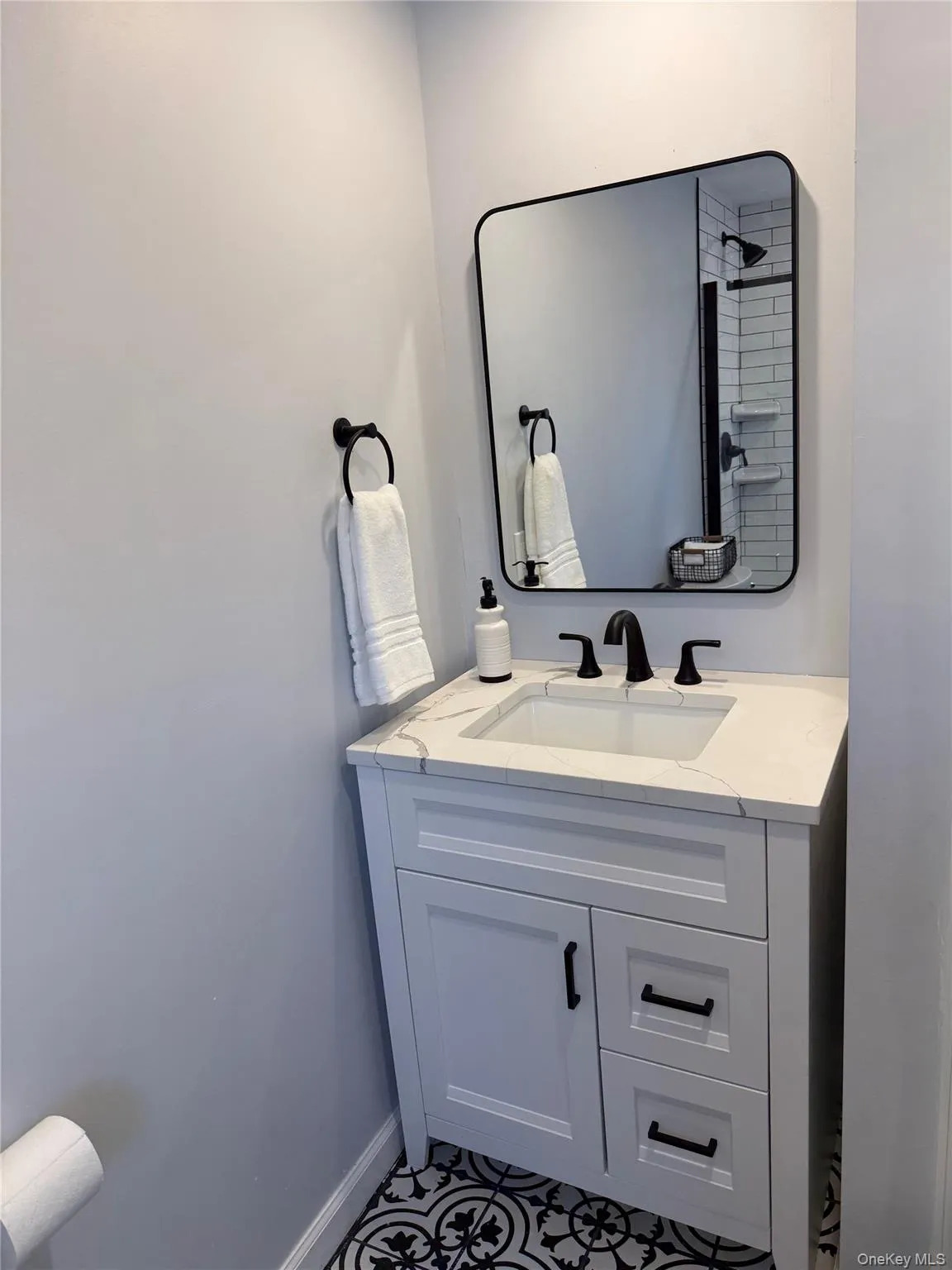 Bathroom featuring vanity and baseboards Bathroom featuring vanity and baseboards