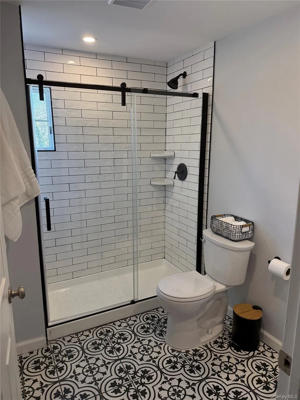 Full bathroom with a shower stall and tile patterned floors Full bathroom with a shower stall and tile patterned floors
