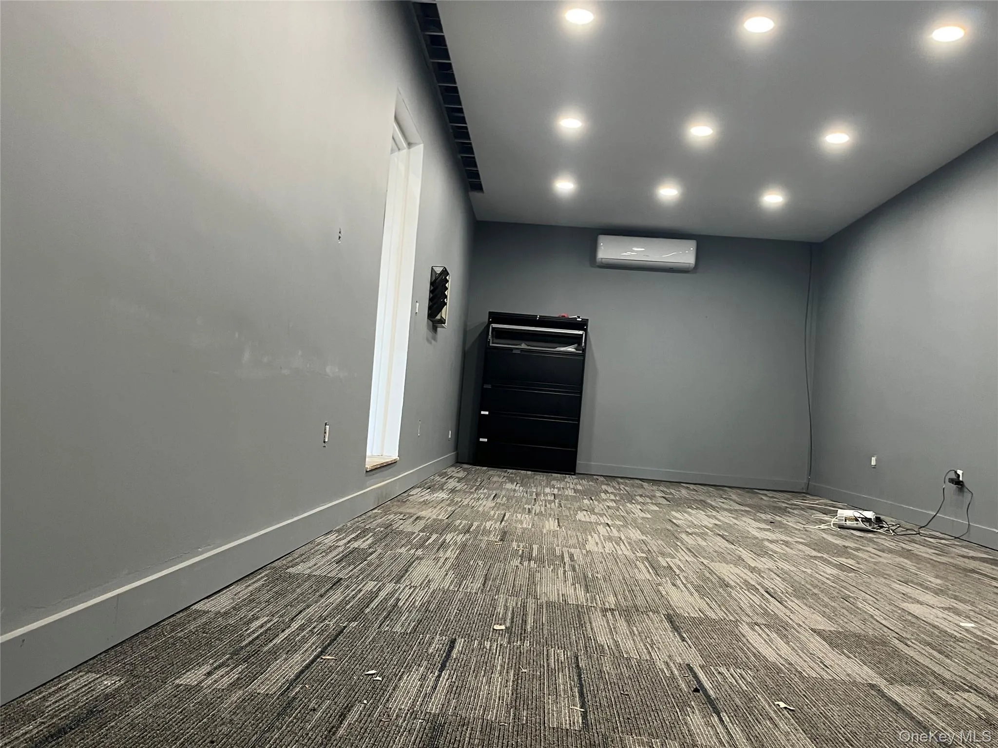 Carpeted empty room featuring recessed lighting and baseboards Carpeted empty room featuring recessed lighting and baseboards