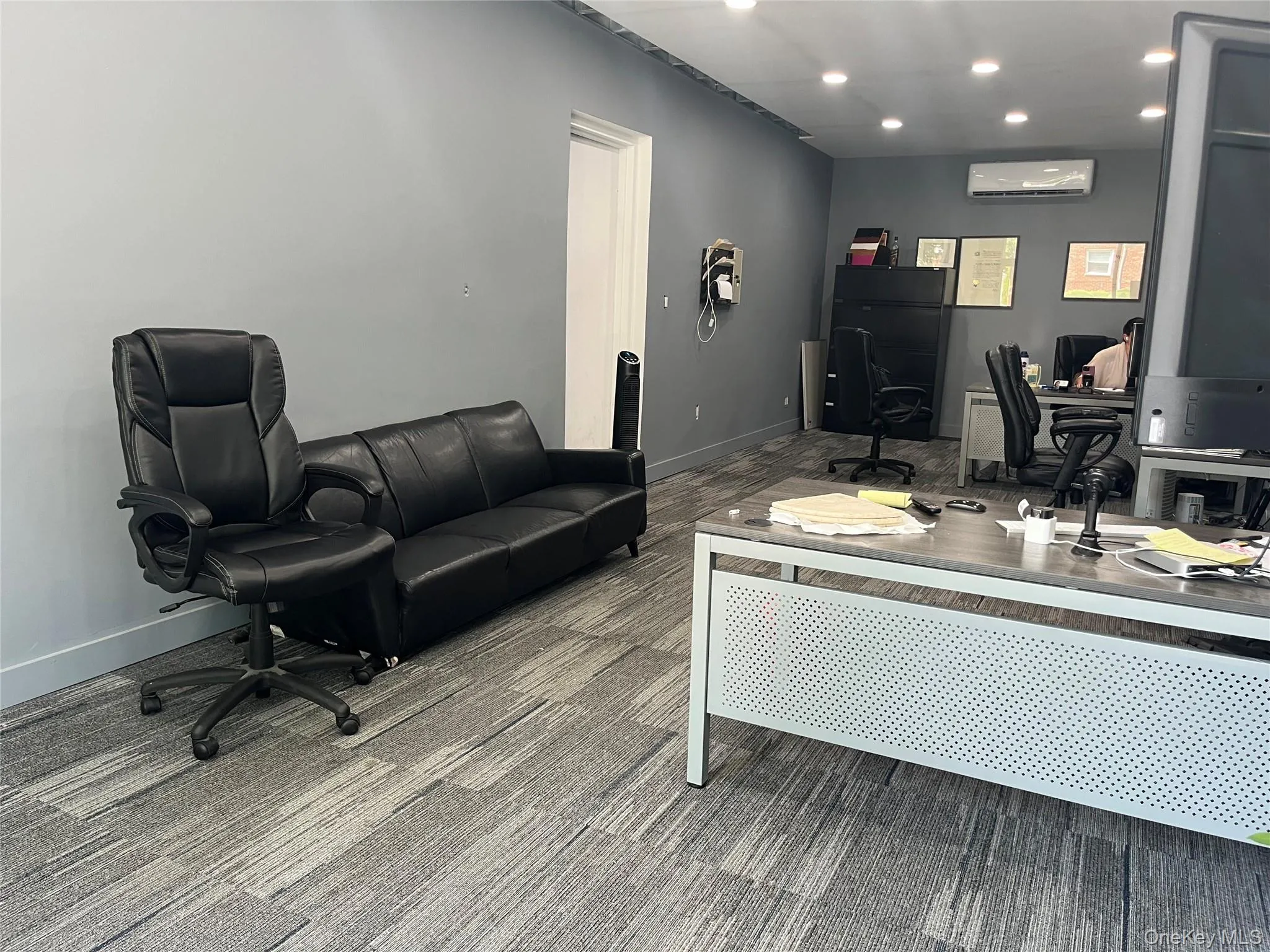 Office space with recessed lighting and carpet flooring Office space with recessed lighting and carpet flooring