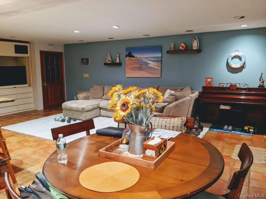 Living area featuring tile patterned floors and recessed lighting Living area featuring tile patterned floors and recessed lighting