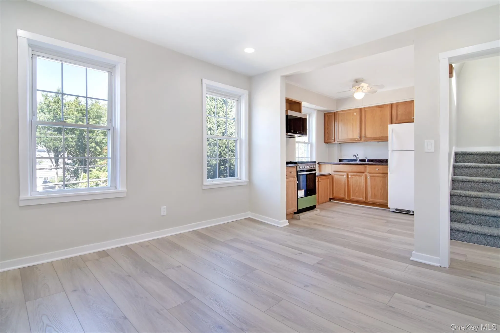 Living Room looking into updated kitchen and stairs leading to upstairs bedrooms. Living Room looking into updated kitchen and stairs leading to upstairs bedrooms.