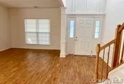 Entrance foyer featuring stairs and wood finished floors Entrance foyer featuring stairs and wood finished floors