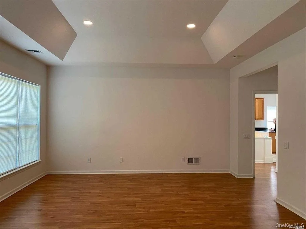 Unfurnished room featuring dark wood finished floors, recessed lighting, and vaulted ceiling Unfurnished room featuring dark wood finished floors, recessed lighting, and vaulted ceiling