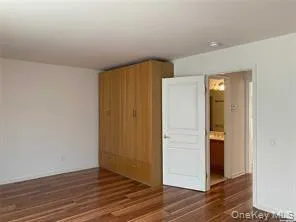 Unfurnished room featuring dark wood-style flooring Unfurnished room featuring dark wood-style flooring