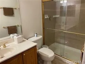 Bathroom featuring vanity and a stall shower Bathroom featuring vanity and a stall shower