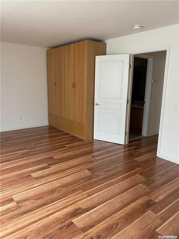 Empty room featuring dark wood-type flooring Empty room featuring dark wood-type flooring