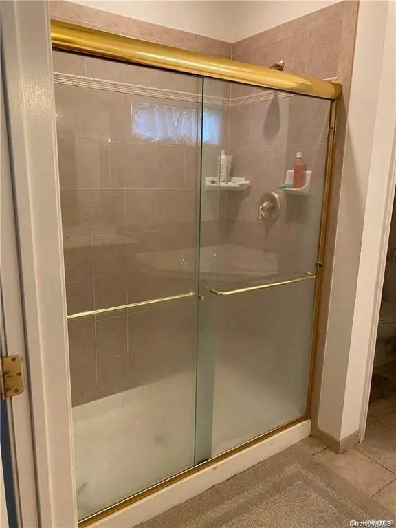 Full bath with a shower stall Full bath with a shower stall