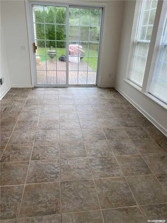 Empty room with baseboards Empty room with baseboards