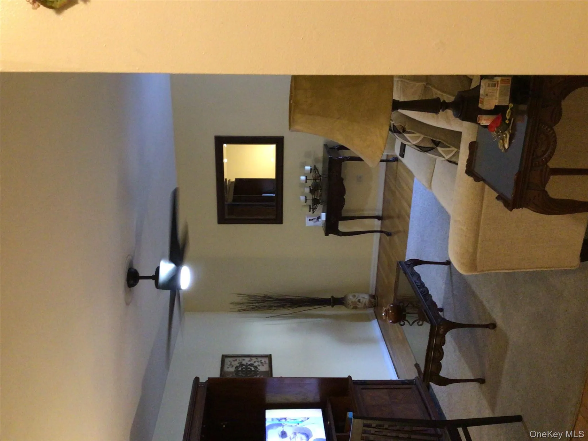 Living room with wood finished floors and a ceiling fan Living room with wood finished floors and a ceiling fan