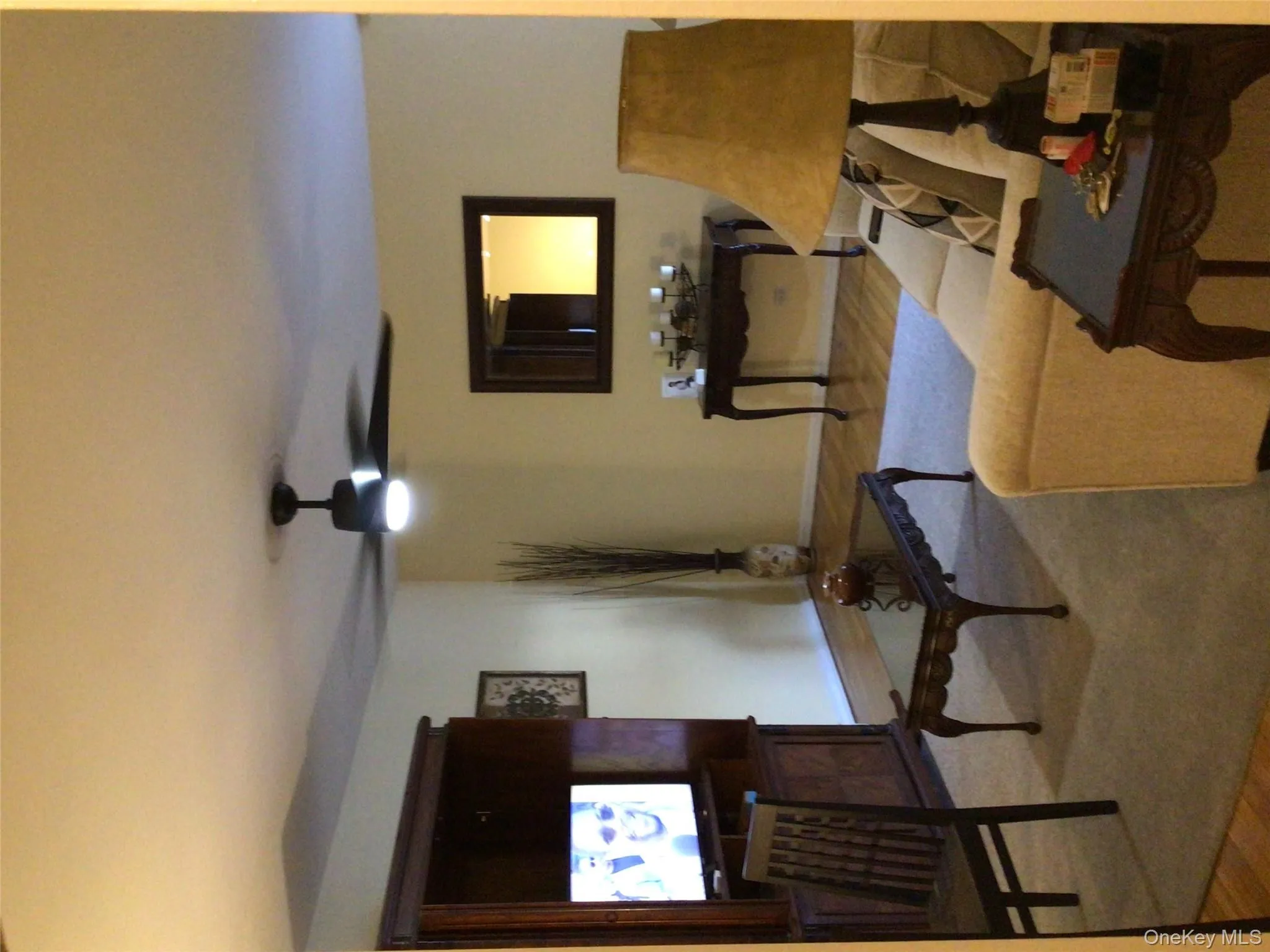 Living area featuring wood finished floors and a ceiling fan Living area featuring wood finished floors and a ceiling fan